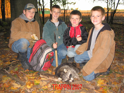 Lucas, Ryan, Kyle & Michael Wolgamott with their first trapped Michigan raccoon
