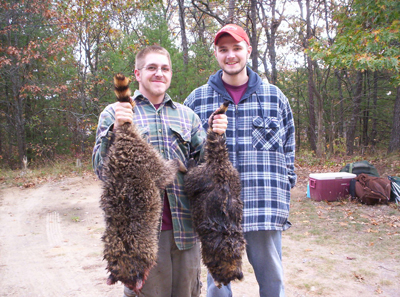 L.T Miller and Rob Fulco from Oscoda, Michigan with a couple of nice raccoon