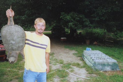Keith Leaym with a big Snapping Turtle he caught in the summer