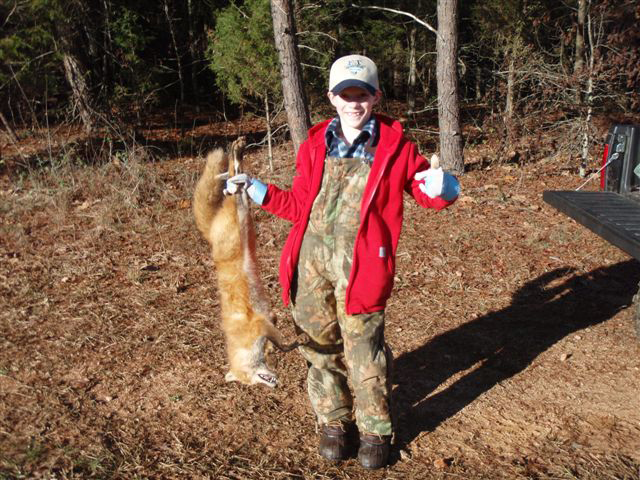 Will Maxwell holding a nice Red fox he and his dad caught in Georgia
