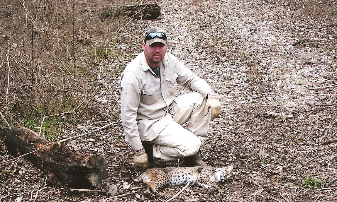 Cody Alphin with a nice spotted bobcat caught on a farm in Arkansas