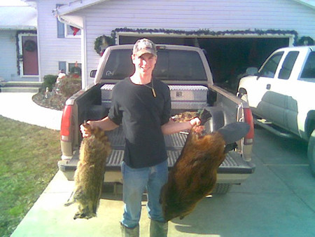 Justin Fisher with a nice big beaver and a raccoon