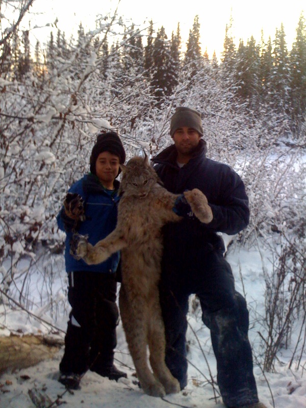 Vince Doria and son Jun with lynx on Alaska winter trapline