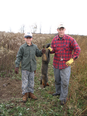 Michigan's Zac Carl and his dad Dave with Zac's first gray fox