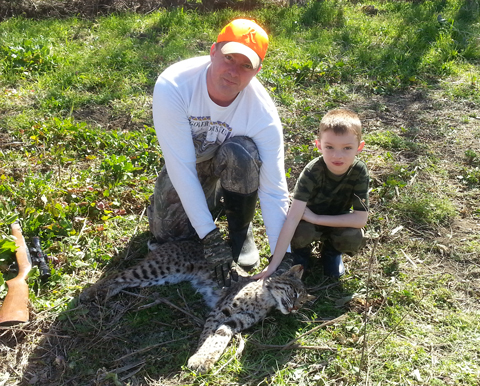 Chris and Coleman DeRusseau with a nice catch of a bobcat in Texas