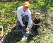 Chris and Coleman DeRusseau with a nice catch of a bobcat in Texas