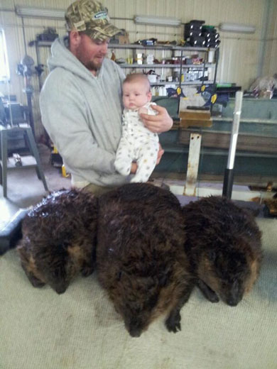 TJ Hannah & his 6 month son Chase Hannah with his 3 beavers that he caught that day in Hamilton County, IL