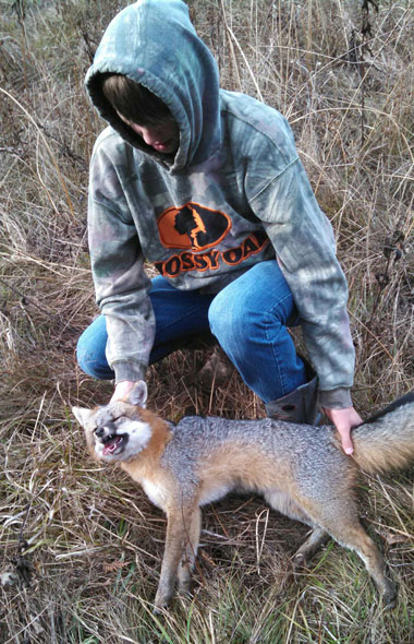 Douglas Weaver III with a grey fox trapped in Sheridan, Michigan.