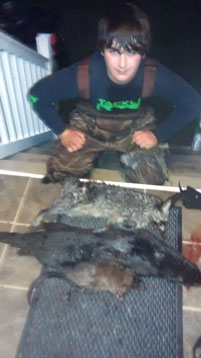 15 year old Jonathan Arnold with his 2nd otter, one of two coons and a muskrat he caught in one morning