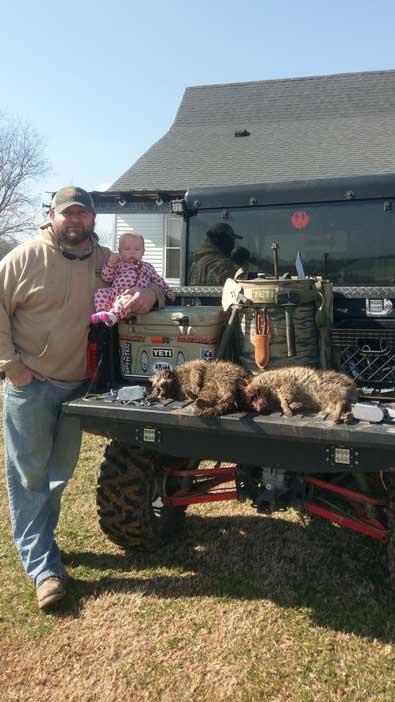 Bryan Pickering and his daughter Ella Rae with a couple of West Tennessee raccoons