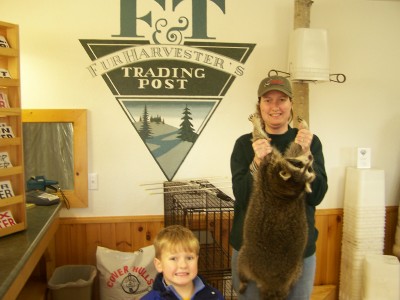 Jen and Colton (Shawn's wife and son) with a nice coon they caught all by themselves