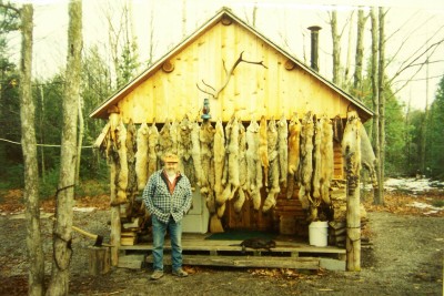 Fred Bloom in front of his Trapper's Cabin