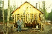 Fred Bloom in front of his Trapper's Cabin